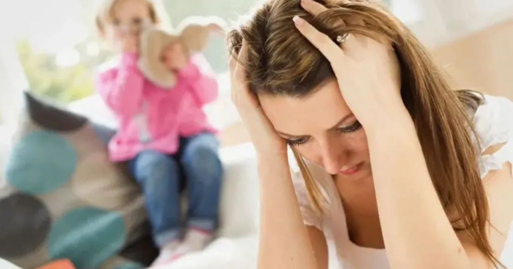 A frustrated parent standing in front of a seated child. The parent's facial expression shows signs of frustration and stress. The child appears calm and seated behind the parent. The image represents the potential negative consequences of keeping a child away from the other parent.