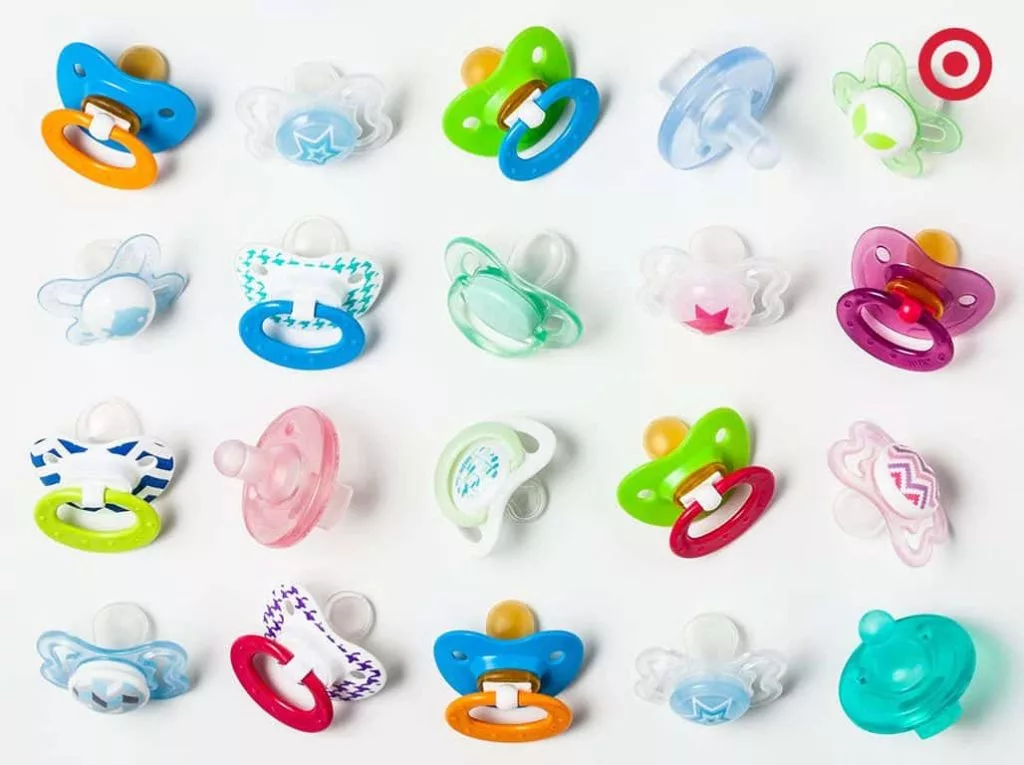 A variety of pacifiers displayed in different colors, shapes, and sizes, representing the options available.