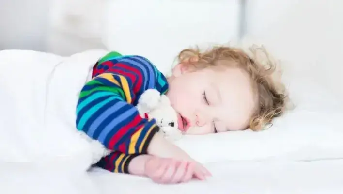 A child is sleeping peacefully after healing from sleep regression. 